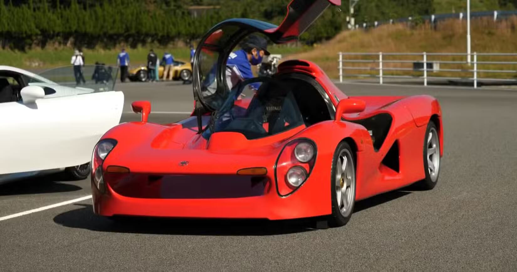 Yamaha OX99-11 front third quarter view at the track, red